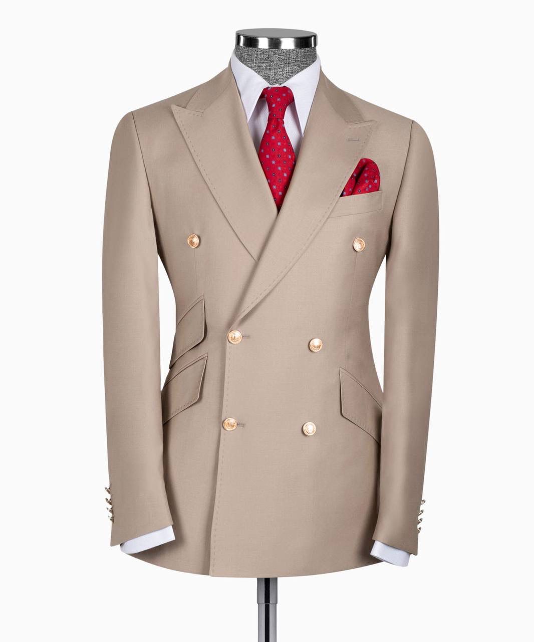 Beige double-breasted suit jacket with a red tie and pocket square on a mannequin against a white background