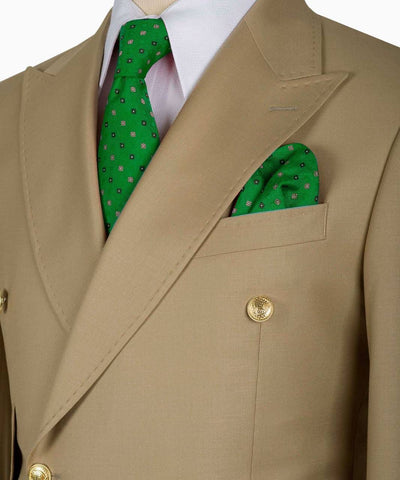 Beige suit jacket with a green patterned tie and pocket square on a white background