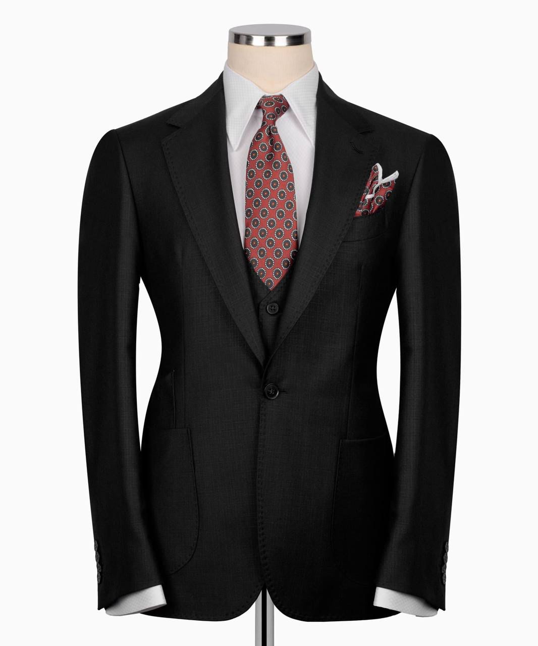 Black suit jacket with a patterned tie and pocket square 