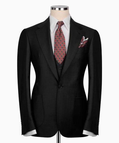 Black suit jacket with a patterned tie and pocket square 