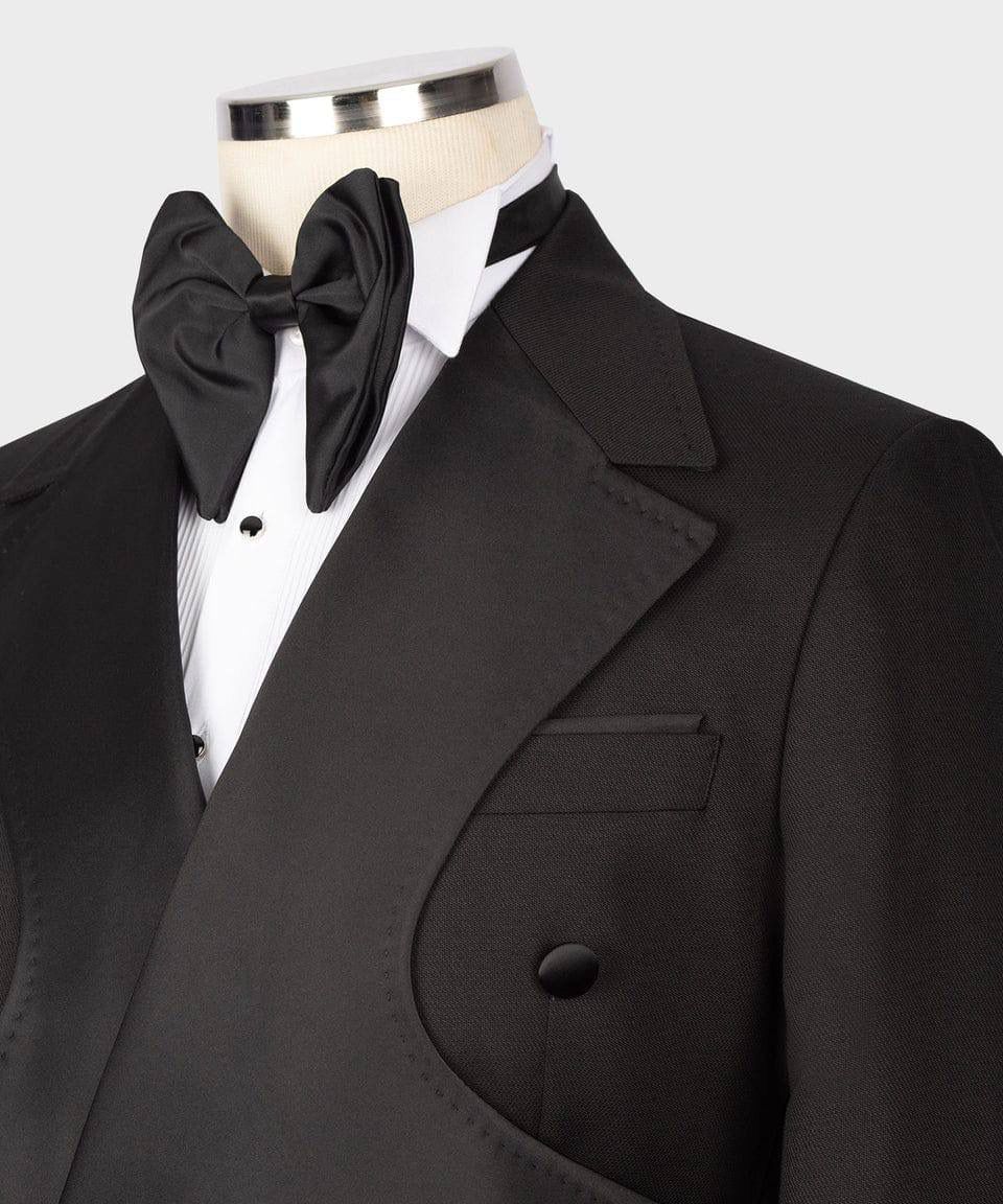 Black tuxedo with bow tie on a mannequin against a white background