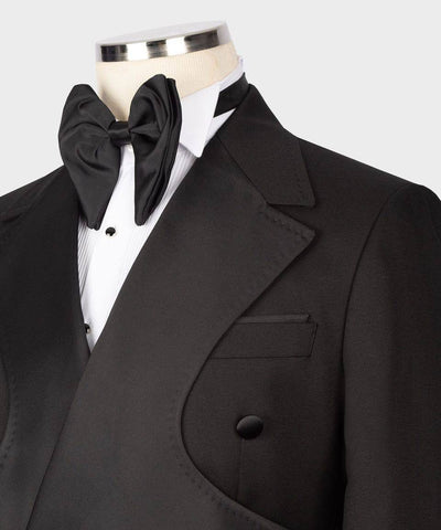 Black tuxedo with bow tie on a mannequin against a white background