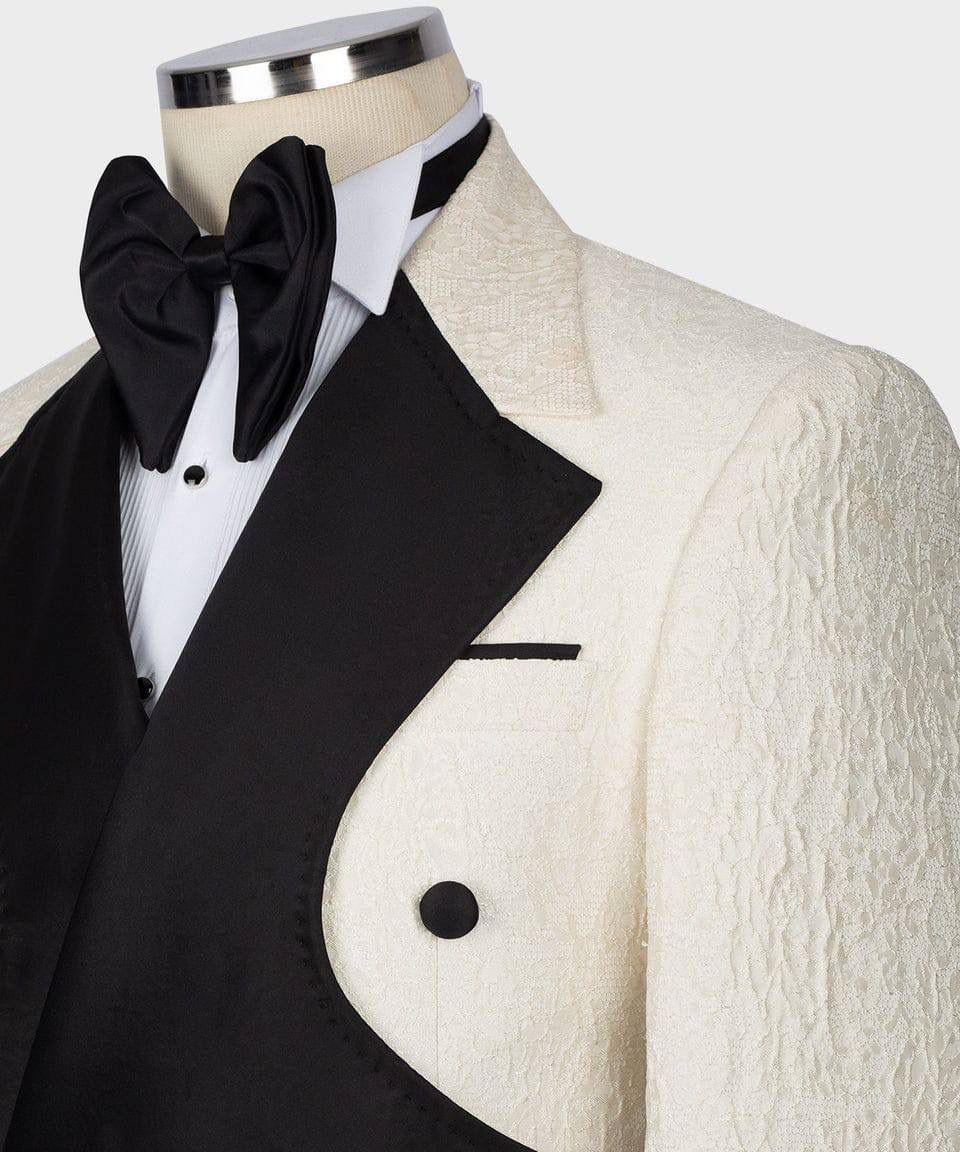 Black tuxedo with white shirt and black bow tie on a mannequin against a white background