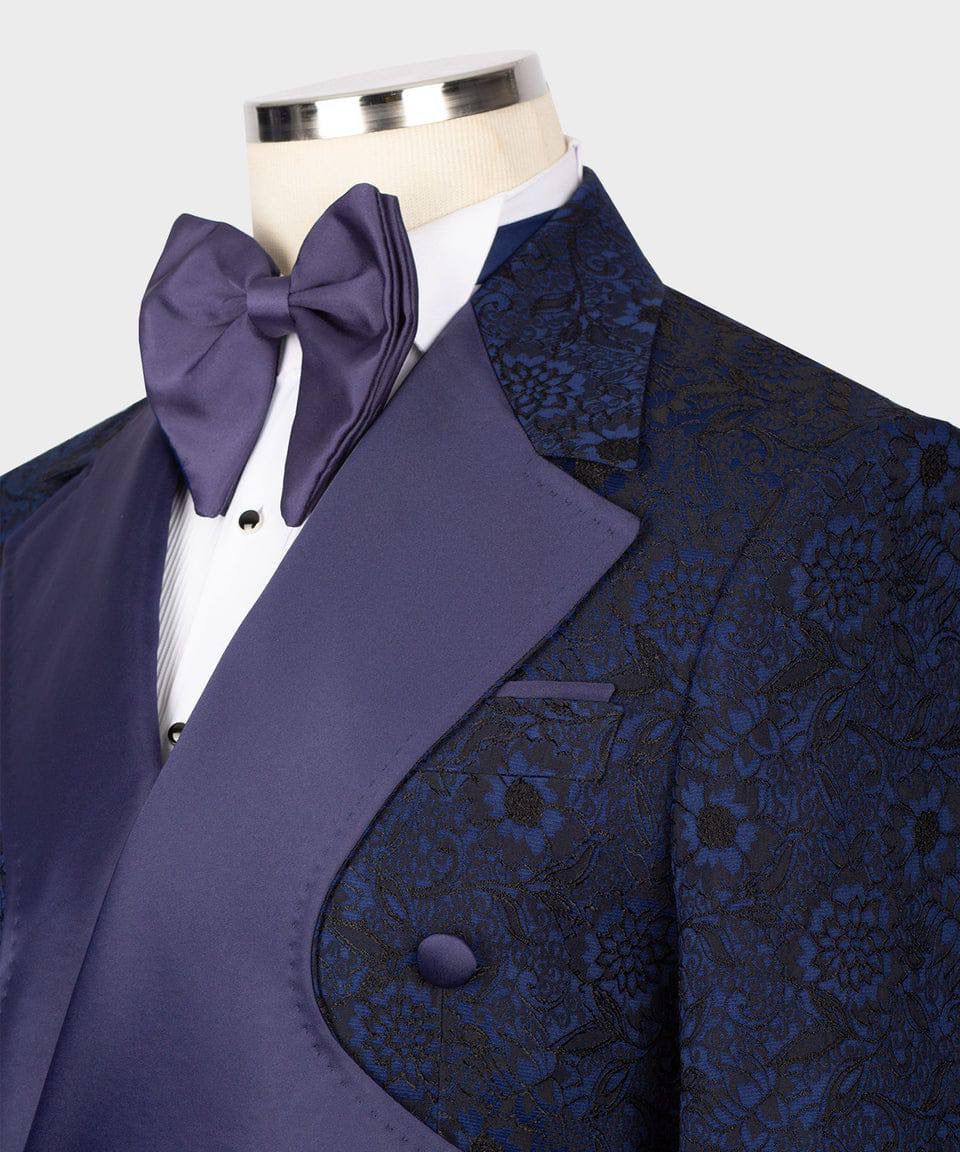 Blue patterned jacket with a purple bow tie on a mannequin against a white background