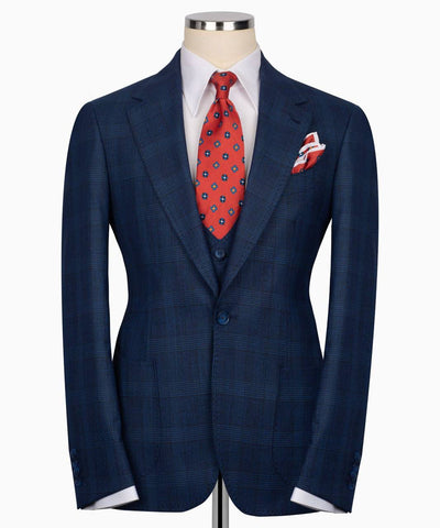 Blue suit jacket with a red tie and pocket square 