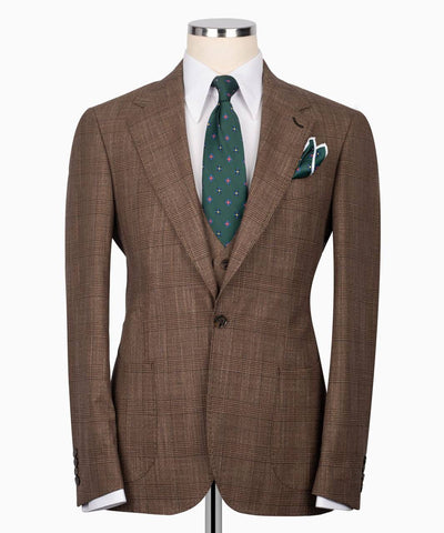 Brown checkered suit on a mannequin with a white shirt, green tie, and pocket square.