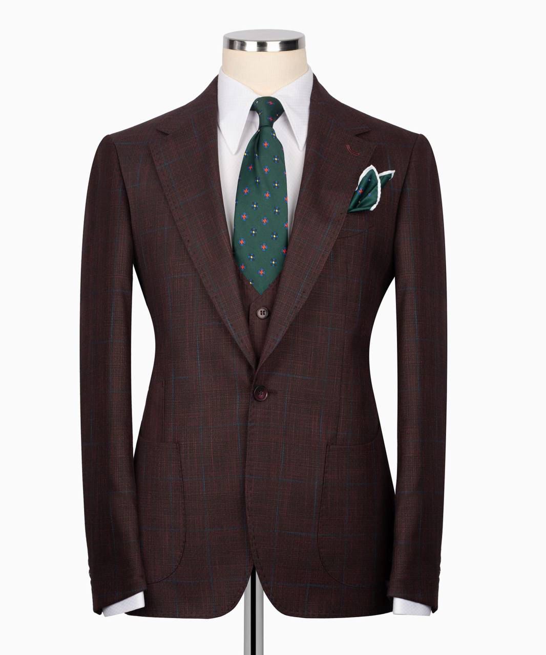 Brown suit jacket with a green tie and pocket square 