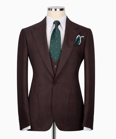 Brown suit jacket with a green tie and pocket square 