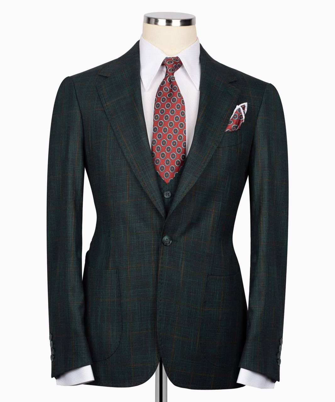 Green suit jacket with a red patterned tie and pocket square 