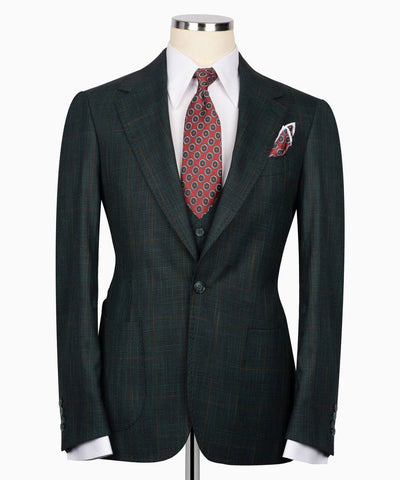 Green suit jacket with a red patterned tie and pocket square 