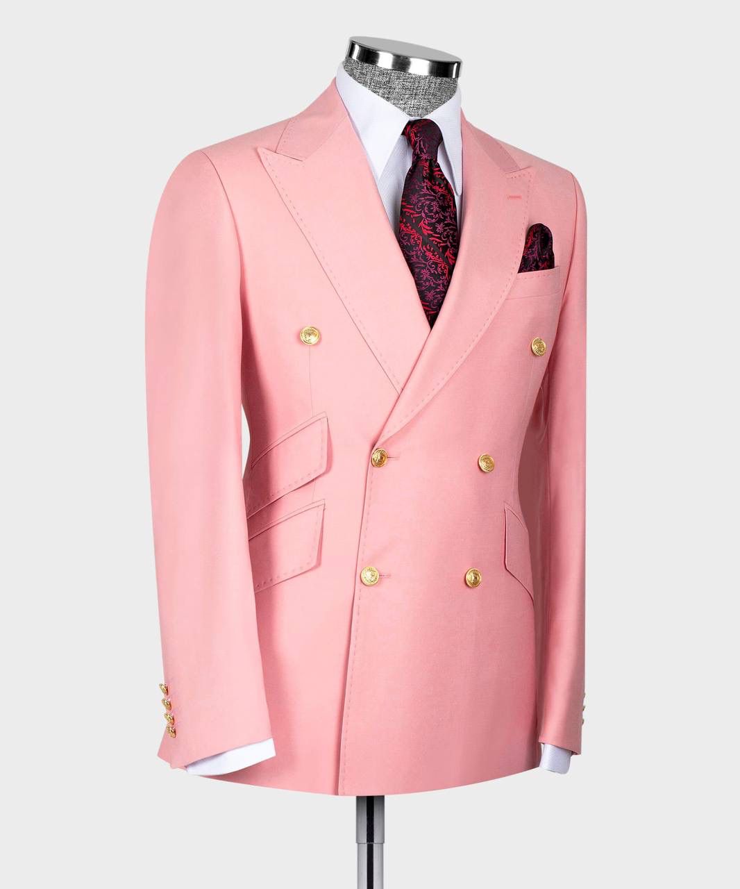 Pink suit jacket with gold buttons on a mannequin against a white background